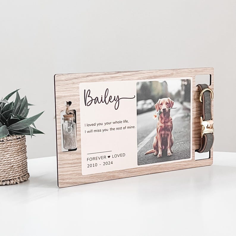 May include: Wooden memorial plaque with a photo of a dog, a small glass jar, and a dog collar. The plaque has the text "Bailey", "I loved you your whole life. I will miss you the rest of mine." and "FOREVER LOVED 2010-2024".