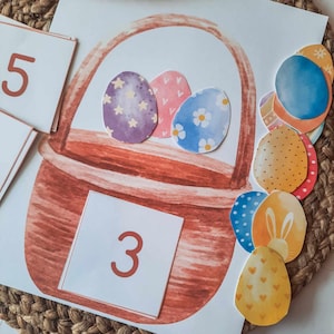 May include: A brown basket with a white handle, filled with three colorful Easter eggs. The eggs have different patterns, including stars, flowers, and hearts. There are also several other colorful Easter eggs scattered around the basket.