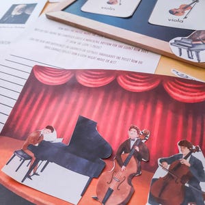 May include: A colorful illustration of a stage with red curtains and three musicians playing instruments. The musicians are playing a piano, a cello, and a double bass. The text "How does the music make a marching rhythm for the lion? How does it show the lion's pride?" is visible on the page.