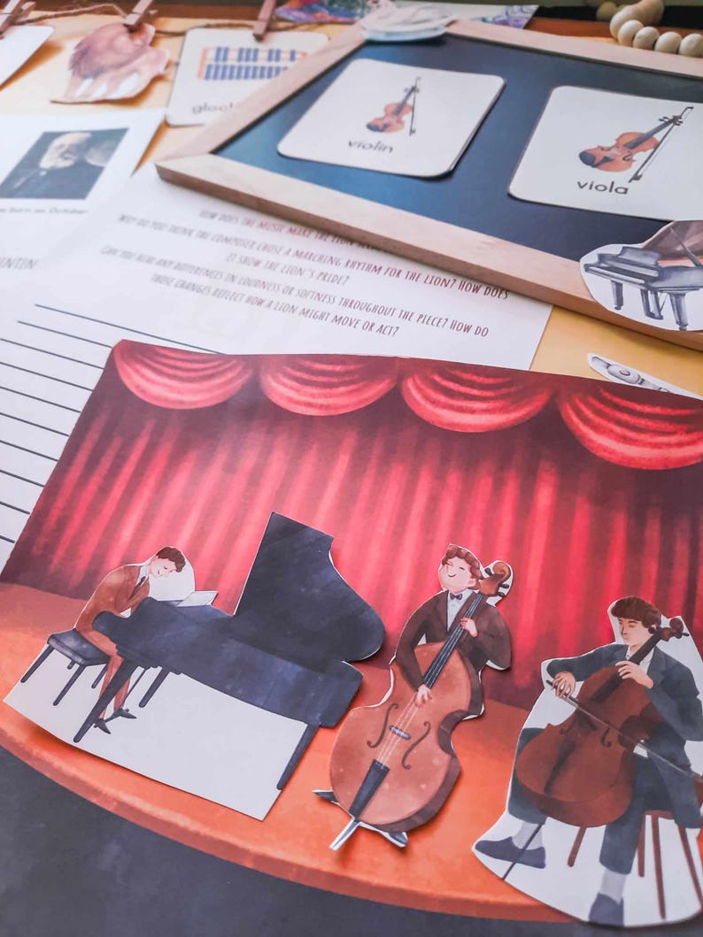 May include: A colorful illustration of a stage with red curtains and three musicians playing instruments. The musicians are playing a piano, a cello, and a double bass. The text "How does the music make a marching rhythm for the lion? How does it show the lion's pride?" is visible on the page.