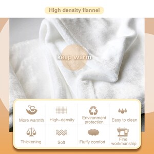 May include: A white flannel blanket with the text "keep warm" in the centre. The blanket is shown folded with the edges of the fabric visible. The image also shows icons representing the features of the blanket, such as "more warmth", "high-density", "environment protection", "easy to clean", "thickening", "soft", "fluffy comfort", and "fine workmanship".