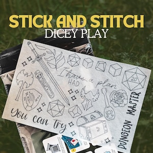 May include: A white fabric panel featuring black line art of dice, a sword, and other fantasy illustrations. Text includes "STICK AND STITCH DICEY PLAY", "I have a plan", "You can try", and "DUNGEON MASTER".