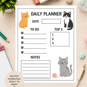 May include: A white 8.5 x 11 inch daily planner with cat illustrations. The planner includes sections for the date, to-do list, top 3 priorities, and notes. The words "DAILY PLANNER" are at the top.