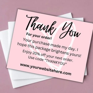 May include: Pink thank you card with a white heart design. The card says "Thank You" in black cursive lettering. The text reads "For your order! Your purchase made my day. I hope this package brightens yours! Enjoy 20% off your next order. Use code "THANKYOU" www.yourwebsitehere.com"