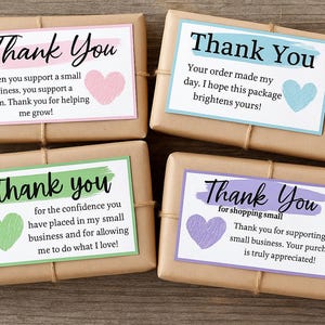 May include: Four parcels wrapped in brown paper, each with a "Thank You" card. The cards feature different coloured borders and heart illustrations. The text conveys appreciation for supporting a small business.