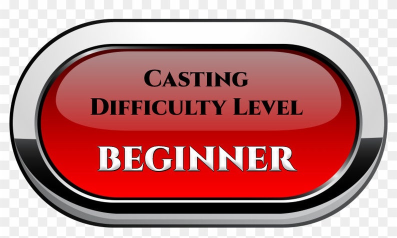 May include: A red oval button with a silver border and black trim. The button has white text that reads 'Casting Difficulty Level Beginner'.