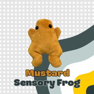 May include: Mustard-colored plush frog with black eyes and a soft, textured appearance. The text "Mustard Sensory Frog" is displayed in a playful font. The frog has a rounded body and outstretched limbs, suggesting a sensory toy.