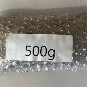 May include: A clear plastic bubble wrap package with a white label that says "500g".