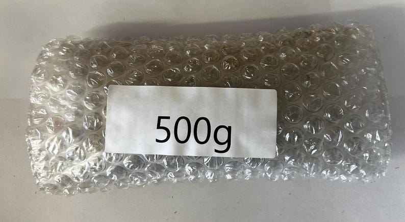May include: A clear plastic bubble wrap package with a white label that says "500g".