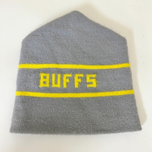 May include: Gray knit beanie with a yellow stripe and the word "BUFFS" in yellow block letters. The beanie has a folded brim and a pointed top. The hat is made of a soft, knitted material.