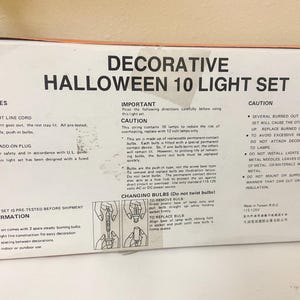 May include: A box for a decorative Halloween 10 light set. The box features text detailing features, important information, and cautions. The set includes a straight line cord, fused plug, and 12-inch spacing between decorations.