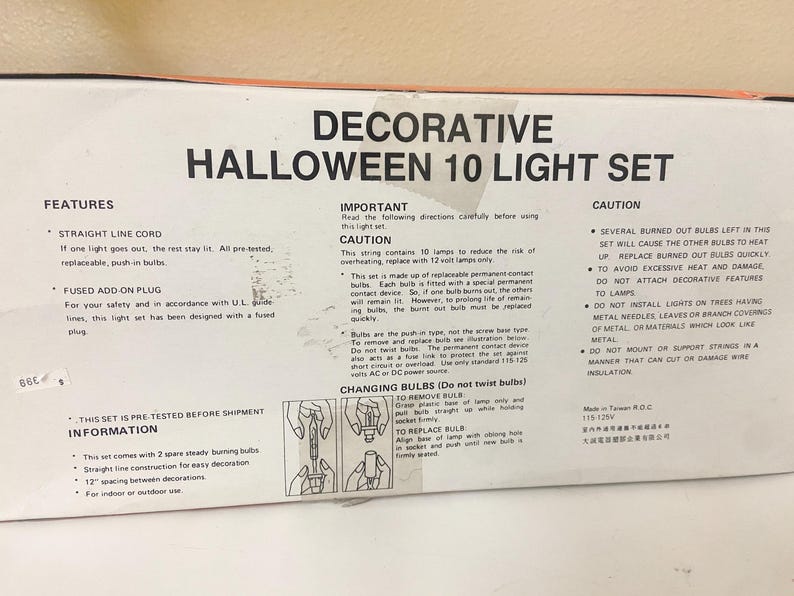May include: A box for a decorative Halloween 10 light set. The box features text detailing features, important information, and cautions. The set includes a straight line cord, fused plug, and 12-inch spacing between decorations.