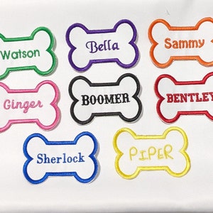 May include: Nine embroidered dog bone patches with different names on each. The names are Watson, Bella, Sammy, Ginger, BOOMER, BENTLEY, Sherlock, PIPER. The patches are in various colors, including green, purple, orange, pink, black, red, blue, and yellow.
