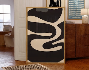 May include: A collection of framed art prints. The largest features a black and cream abstract design. Above, a print with "MATISSE" and a black figure. To the right, a blue print with "THANKS FOR COMING". The prints are displayed on a wooden floor.
