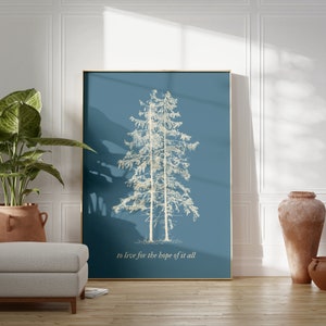 May include: A framed print with a blue background and a white silhouette of two pine trees. The text "to live for the hope of it all" is printed below the trees.
