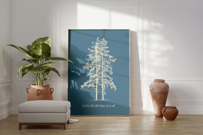 May include: A framed print with a blue background and a white silhouette of two pine trees. The text "to live for the hope of it all" is printed below the trees.