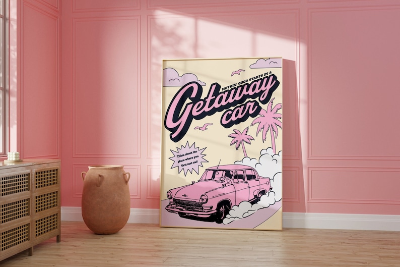 May include: A pink and yellow vintage-style poster with the text "NOT EVERY GOOD TRIP STARTS IN A GETAWAY CAR" and a pink car driving on a road with palm trees and clouds in the background.