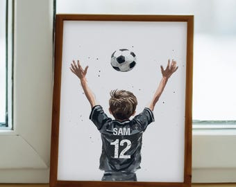 May include: A framed illustration of a young person wearing a black soccer jersey with the name "SAM" and the number "12" on the back. The person is raising their arms in the air with a soccer ball above their head.