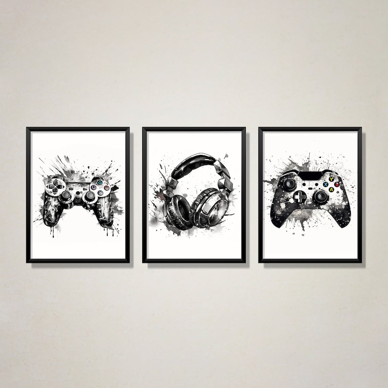 May include: Three black and white framed prints with a gaming theme. The prints feature a video game controller, a pair of headphones, and a second video game controller.