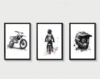 May include: Three black and white framed prints of motocross riders. The first print shows a motocross bike, the second print shows a rider wearing a helmet and jersey with the number 10, and the third print shows a close-up of a motocross helmet.
