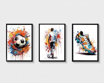 May include: Set of three framed art prints featuring soccer themes. One print shows a soccer ball with colorful paint splatter, another depicts a soccer player, and the third showcases a soccer cleat, all with a vibrant, artistic style.