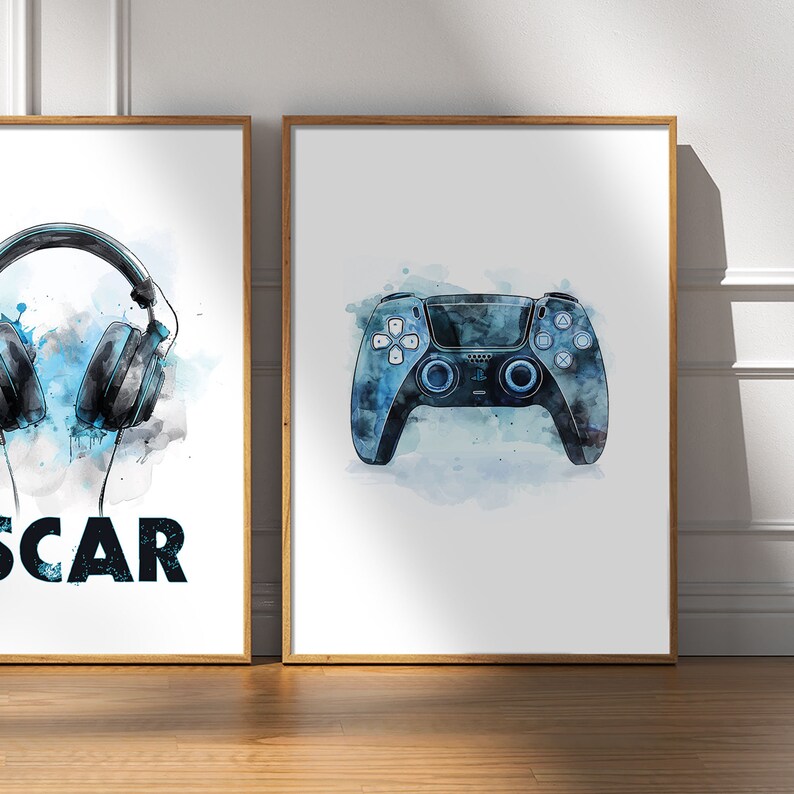May include: Two framed prints with a gamer theme. The left print features a pair of blue headphones with a watercolor effect and the word "SCAR" below. The right print features a blue and black video game controller with a watercolor effect.