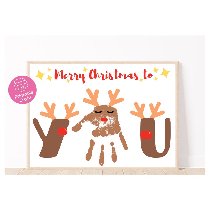 May include: Printable Christmas craft with the words "Merry Christmas to YOU" and reindeer handprint art. The reindeer are brown with red noses and antlers. The handprint is brown with red lips and closed eyes.