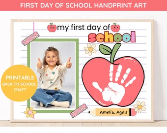 May include: Printable first day of school handprint art craft with a photo frame, a red apple with a handprint, and the text "my first day of school".