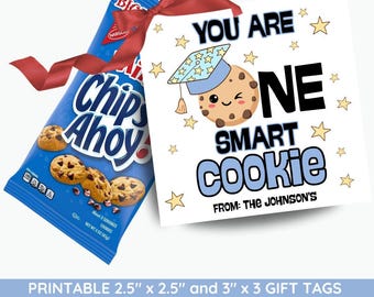 May include: A blue Chips Ahoy! cookie bag tied with a red ribbon next to a white gift tag. The tag says "You are one smart cookie" with a cartoon cookie wearing a graduation cap. The tag is decorated with stars.