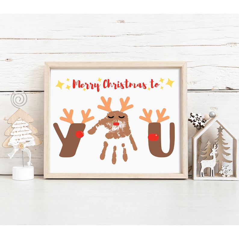 May include: A white framed print with the text "Merry Christmas to You" in red. The "You" is made up of three brown reindeer handprints with red noses.