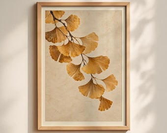 May include: A framed wall art print featuring a botanical illustration of a ginkgo branch with golden-yellow fan-shaped leaves. The artwork is set against a textured, cream-colored background and enclosed in a light-toned wooden frame.