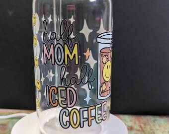 May include: A clear glass jar with a bamboo lid and a straw. The jar has a colorful design that says "half mom half iced coffee".