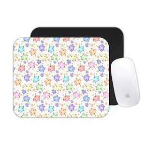 May include: A white mouse pad with a colorful pattern of cartoon creatures and stars, a black mouse pad, and a white computer mouse. The mouse pad has a rectangular shape with rounded corners. The mouse is a sleek, modern design.