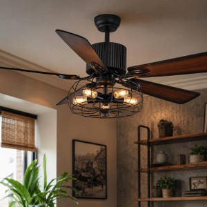 May include: A ceiling fan with five dark wood-toned blades and a matte black motor housing. A central black wire cage encloses four exposed filament light bulbs, providing warm illumination. The fan is mounted to the ceiling with a black canopy.