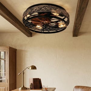 May include: A circular ceiling fan light fixture featuring a black metal cage frame with a diamond-patterned mesh band. The unit contains multiple exposed light bulbs and dark copper-toned fan blades positioned within the central structure.