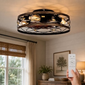 Könnte beinhalten: Eine runde Deckenventilator-Leuchte mit einem schwarzen Metallkäfigrahmen und holzfarbenen Akzenten. Die Leuchte enthält mehrere sichtbare Glühbirnen und innenliegende Ventilatorflügel. Eine weiße Fernbedienung mit runden Tasten ist im Vordergrund zu sehen.