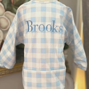 May include: A white ceramic mug with a black handle and the text "But First, Coffee" in a black, bold font. The mug is on a white surface. The mug is 4 inches tall.