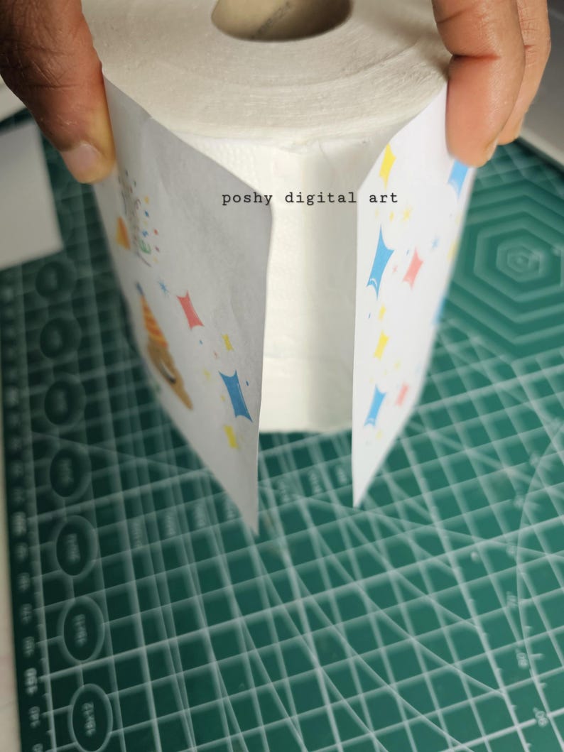 May include: A roll of white toilet paper with a colorful design on the outside. The design features blue, red, and yellow shapes and the text "poshy digital art".