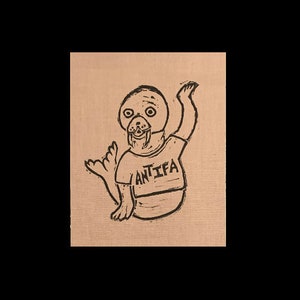 May include: A black and white illustration of a walrus wearing a shirt that says "ANTIFA".