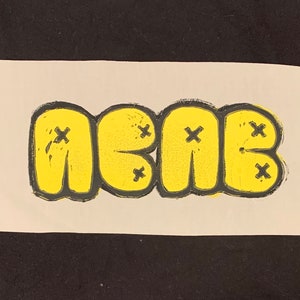 May include: A yellow print of the word "NEAR" in a bubble letter style with black outlines and small black "x" marks.