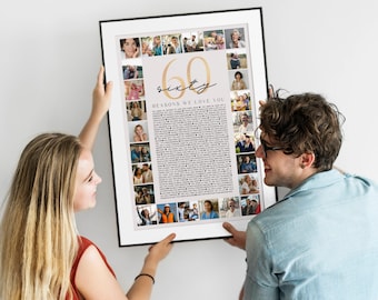 May include: A framed print with a black border, held by two people. The print features a collage of photos surrounding the text "60 Reasons We Love You." The number "60" is in gold script. The background is a light beige color.