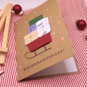 Weihnachtskarte handgemacht | Weihnachtspost! mit Geschenken in 3D und Schlitten auf Kraftpapier-Karte
