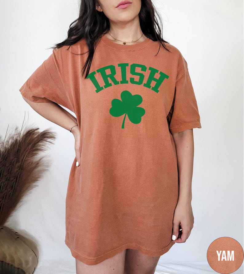 a woman wearing an irish t - shirt with a shamrock on it