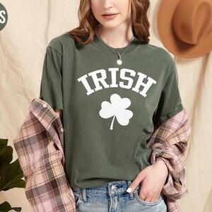 a woman wearing a green shirt with a shamrock on it