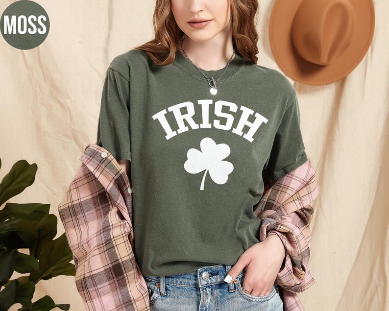 a woman wearing a green shirt with a shamrock on it