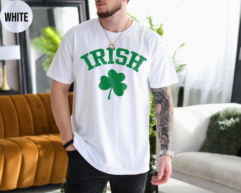 a man wearing a white shirt with a shamrock on it