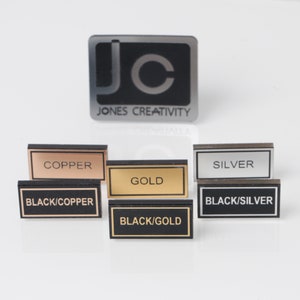 May include: Six small rectangular signs with black borders and white text. The signs display the following metal finishes: Copper, Silver, Gold, Black/Copper, Black/Silver, and Black/Gold.