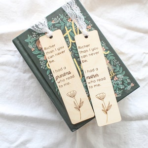 May include: Two wooden bookmarks with laser-engraved text and floral designs. The text reads "Richer than I you can never be. I had a grandma/mother who read to me."