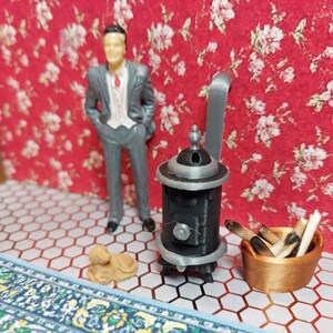 1:24 scale (half scale) pot belly wood stove 3d printed in  black and gray pla plastic with free copper colored wood bin. for dollhouse.