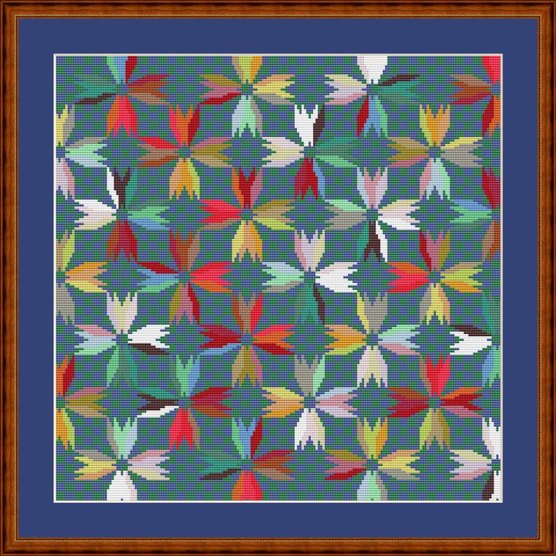 May include: A cross-stitch pattern featuring a repeating floral motif in shades of red, yellow, white, and green against a dark teal background. The design is enclosed within a blue mat and a brown wooden frame, creating a square wall art piece.